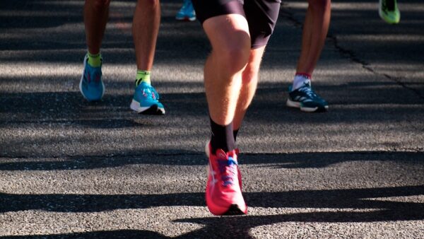 a group of people running down a street