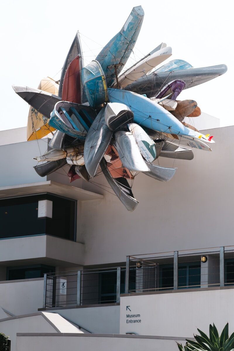 A sculpture made of colorful boats on a white building
